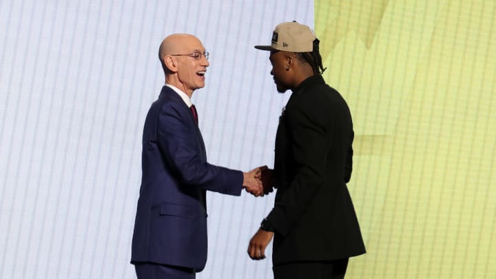 Jun 26, 2024; Brooklyn, NY, USA; Isaiah Collier shakes hands with NBA commissioner Adam Silver after being selected in the first round by the Utah Jazz in the 2024 NBA Draft at Barclays Center. Mandatory Credit: Brad Penner-USA TODAY Sports