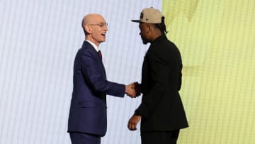 Jun 26, 2024; Brooklyn, NY, USA; Isaiah Collier shakes hands with NBA commissioner Adam Silver after being selected in the first round by the Utah Jazz in the 2024 NBA Draft at Barclays Center. Mandatory Credit: Brad Penner-USA TODAY Sports
