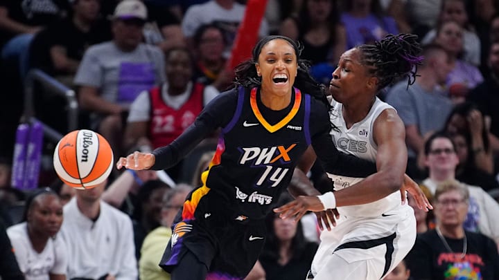 Aces guard Chelsea Gray (12) knocks away the ball from Mercury forward DeWanna Bonner (14) during a game at PHX Arena in Phoenix, on Aug. 15, 2025.