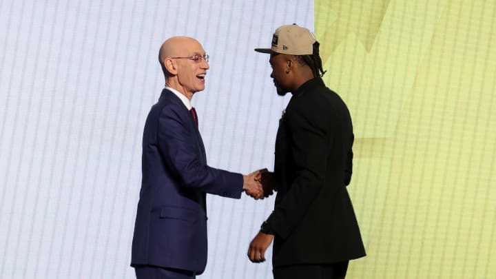 Jun 26, 2024; Brooklyn, NY, USA; Isaiah Collier shakes hands with NBA commissioner Adam Silver after being selected in the first round by the Utah Jazz in the 2024 NBA Draft at Barclays Center. Mandatory Credit: Brad Penner-USA TODAY Sports
