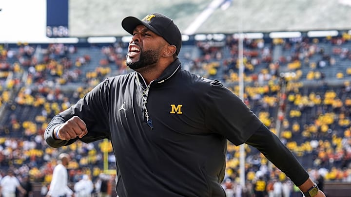 Sep 7, 2024; Ann Arbor, Michigan, USA; Michigan head coach Sherrone Moore cheers with the student section during warm ups at Michigan Stadium. Mandatory Credit: Junfu Han-USA TODAY Network via Imagn Images