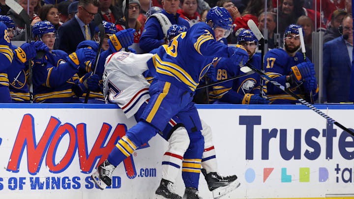 Jan 31, 2026; Buffalo, New York, USA;  Buffalo Sabres defenseman Rasmus Dahlin (26) checks Montréal Canadiens center Oliver Kapanen (91) as he goes after a loose puck during the first period at KeyBank Center. Mandatory Credit: Timothy T. Ludwig-Imagn Images