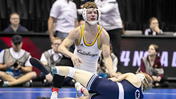 Jore Volk of Wyoming wrestles with Braeden Davis of Penn State during the semifinal of the NCAA Wrestling Championships at T-Mobile Center in Kansas City, Mo., on March 22, 2024.