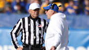 Nov 29, 2025; Pittsburgh, Pennsylvania, USA;  Pittsburgh Panthers head coach Pat Narduzzi (right) talks with referee Riley Johnson (left) during the first quarter against the Miami Hurricanes at Acrisure Stadium. Mandatory Credit: Charles LeClaire-Imagn Images
