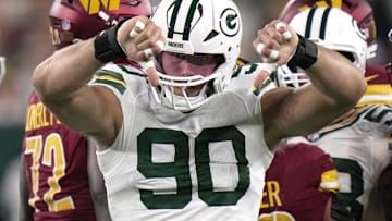 Green Bay Packers defensive end Lukas Van Ness (90 cleats tacking Washington Commanders running back Austin Ekeler for a loss during the first quarter of their game Thursday, September 11, 2025 at Lambeau Field in Green Bay, Wisconsin.