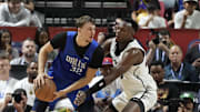 Jul 12, 2025; Las Vegas, NV, USA; San Antonio Spurs forward Osayi Osifo (26) defends against Dallas Mavericks forward Cooper Flagg (32) in the second quarter of their game at Thomas & Mack Center. Mandatory Credit: Candice Ward-Imagn Images