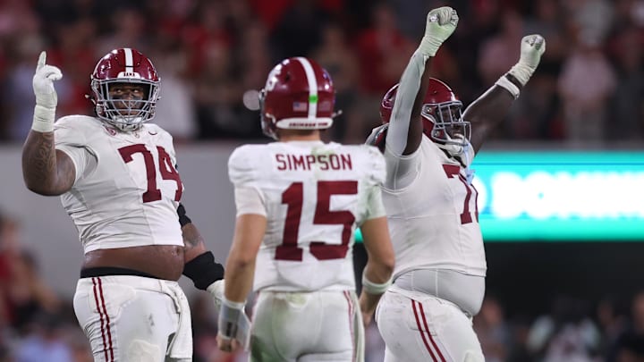 Alabama Crimson Tide offensive lineman Kadyn Proctor (74) celebrates with quarterback Ty Simpson (15)