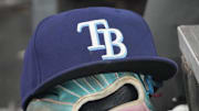 Sep 26, 2025; Toronto, Ontario, CAN; The hat and glove of Tampa Bay Rays third baseman Junior Caminero (13) in the dugout during the game against the Toronto Blue Jays at Rogers Centre. 