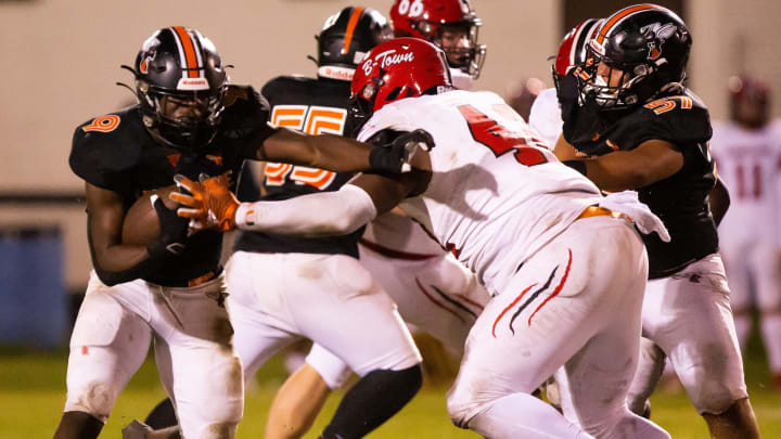 Hawthorne Hornets running back Keenon Johnson (9) tries to avoid getting tackled by Blountstown Tigers Artavius Jones (42). The Hawthorne Hornets hosted the Blountstown Tigers at Hawthorne High School in Hawthorne, FL on Thursday, November 30, 2023 in the Class 1R State Semis Football. The Hornets defeated the Tigers 49-0 and advance to the State Championship game next Thursday in Tallahassee. [Doug Engle/Gainesville Sun]