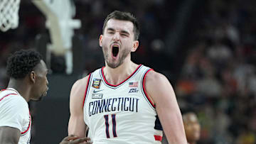 Apr 6, 2024; Glendale, AZ, USA; Connecticut Huskies forward Alex Karaban (11) celebrates after a play against the Alabama Crimson Tide with guard Hassan Diarra (10) during the second half in the semifinals of the men's Final Four of the 2024 NCAA Tournament at State Farm Stadium. Mandatory Credit: Bob Donnan-Imagn Images