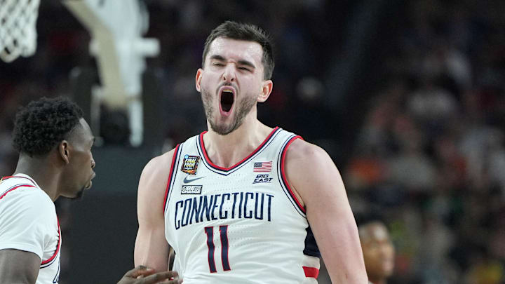 Apr 6, 2024; Glendale, AZ, USA; Connecticut Huskies forward Alex Karaban (11) celebrates after a play against the Alabama Crimson Tide with guard Hassan Diarra (10) during the second half in the semifinals of the men's Final Four of the 2024 NCAA Tournament at State Farm Stadium. Mandatory Credit: Bob Donnan-Imagn Images