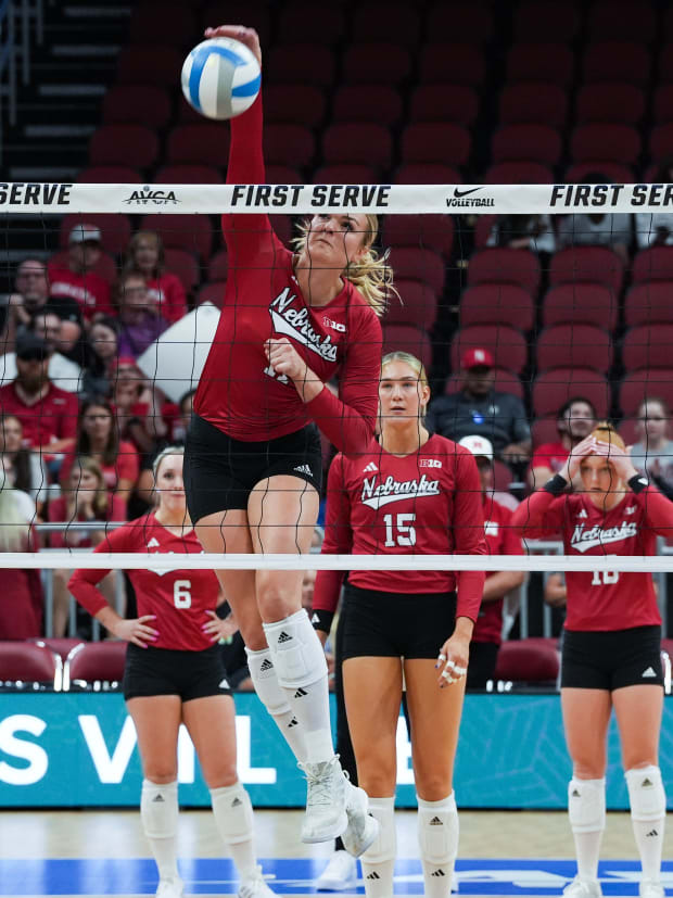 Nebraska volleyball players warm up ahead of their match in the AVCA First Serve Showcase.