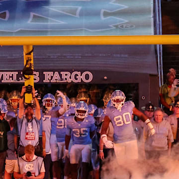 UNC entering Kenan Stadium through smoke before its game against TCU on Sept. 1, 2025.