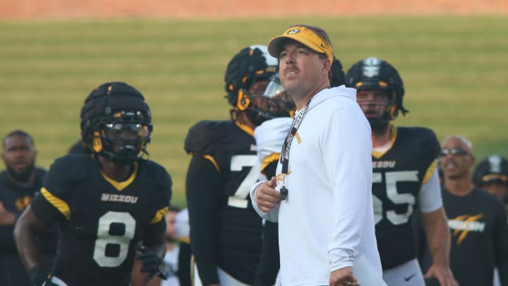 Aug.17, 2024; Columbia, Missouri, USA; Missouri Tigers head coach Eli Drinkwitz looks onto the practice field at the team's annual fan night practice at Faurot Field.