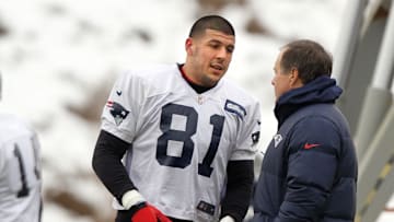 2013: Patriots head coach Bill Belichick talks with tight end Aaron Hernandez during practice.