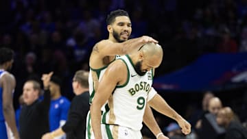 Nov 15, 2023; Philadelphia, Pennsylvania, USA; Boston Celtics forward Jayson Tatum (0) congratulates guard Derrick White (9) after his three-pointer against the Philadelphia 76ers during the fourth quarter at Wells Fargo Center. Mandatory Credit: Bill Streicher-Imagn Images
