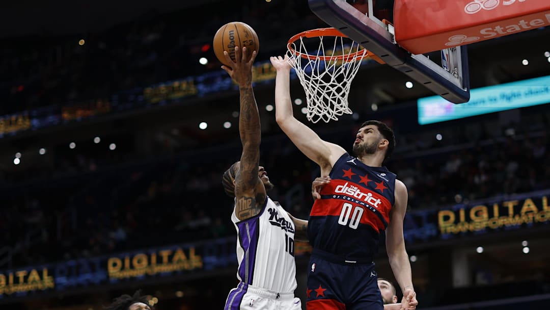 Apr 2, 2025; Washington, District of Columbia, USA; Washington Wizards forward Tristan Vukcevic (00) blocks the shot of Sacramento Kings forward DeMar DeRozan (10) in the first half at Capital One Arena. Mandatory Credit: Geoff Burke-Imagn Images