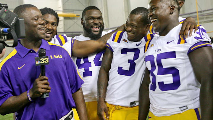 August 9, 2011; Baton Rouge, LA, USA; LSU Tigers running backs coach Frank Wilson laughs with the running backs as they speak to a local television station during the LSU football media day at the Charles McClendon Practice Facility. Mandatory Credit: Crystal LoGiudice-Imagn Images