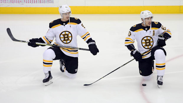 Hockey players stretch during warmup