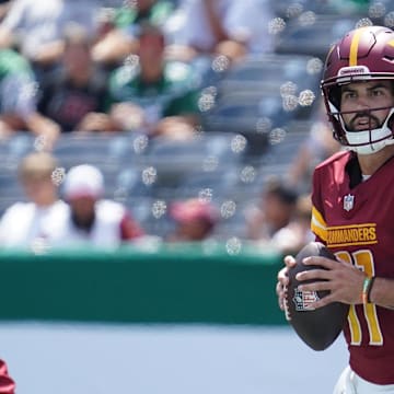 Aug 10, 2024; East Rutherford, New Jersey, USA; Washington Commanders quarterback Sam Hartman (11) surveys the field during the third quarter against the New York Jets at MetLife Stadium. Mandatory Credit: Lucas Boland-Imagn Images