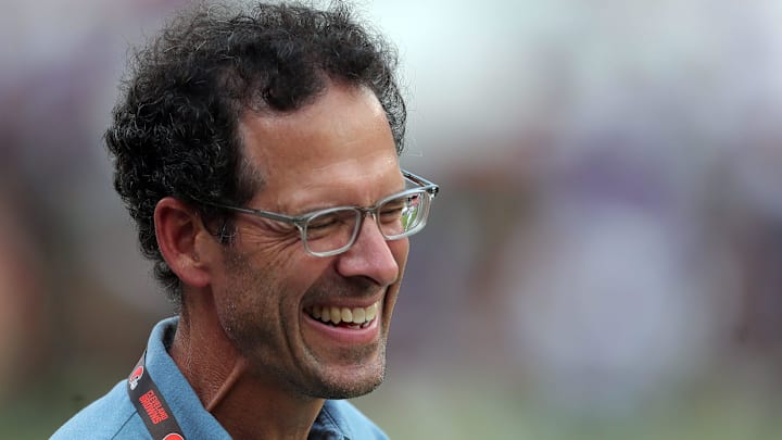 Cleveland Browns chief strategy officer Paul DePodesta laughs on the sideline before an NFL preseason football game at Cleveland Browns Stadium