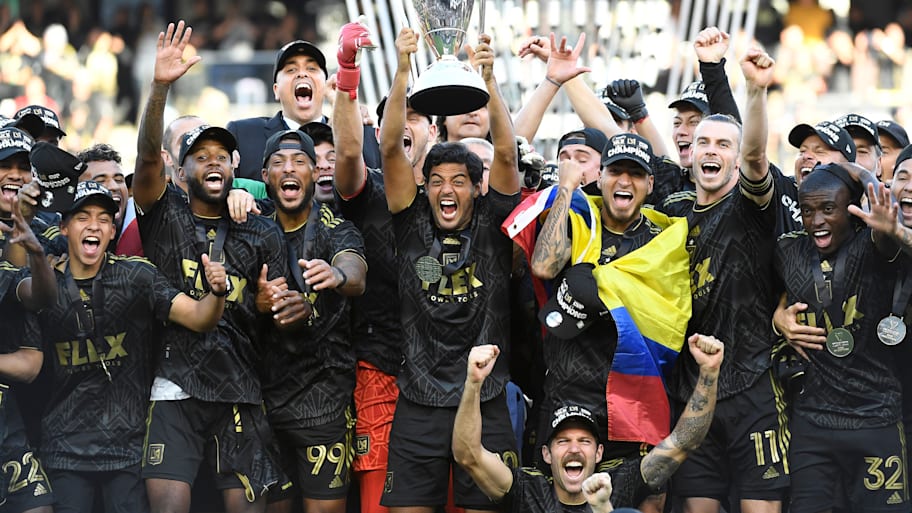 Carlos Vela lifting the MLS trophy. 