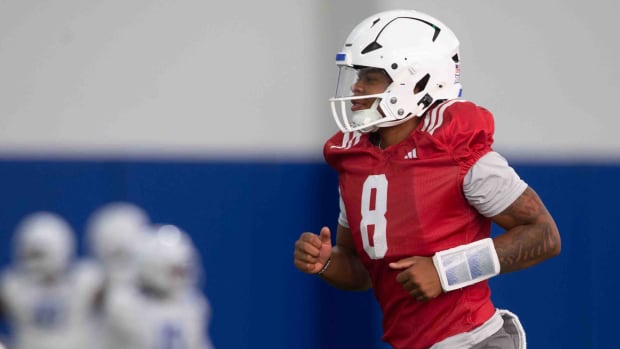 Kansas freshman quarterback Isaiah Marshall (8) runs to the next area during an indoor practice Wednesday, July 31.