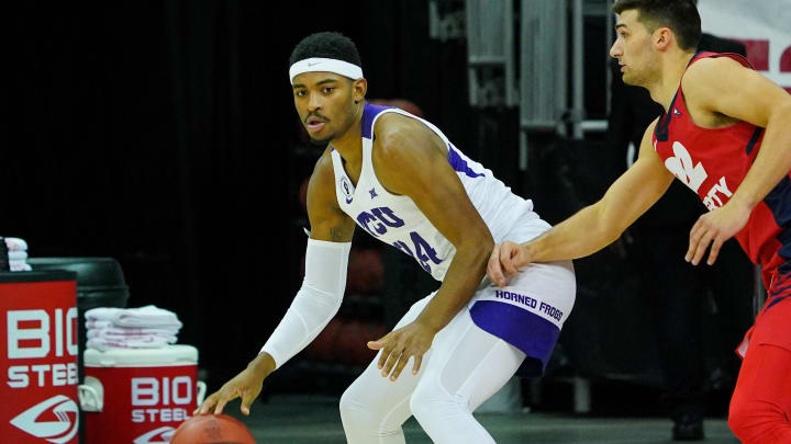 Nov 29, 2020; Kansas City, MO, USA; TCU Horned Frogs forward Kevin Easley Jr. (34) dribbles the ball against the Liberty Flames forward Kyle Rode (22) during the first half at T-Mobile Center. Mandatory Credit: Jay Biggerstaff-USA TODAY Sports