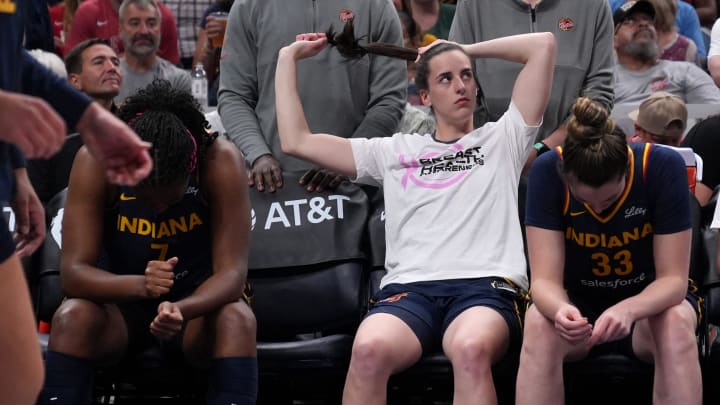 Indiana Fever guard Caitlin Clark (22) ties up her hair before a game against the Seattle Storm on Sunday, Aug. 18, 2024, at Gainbridge Fieldhouse in Indianapolis. The Fever defeated the Storm 92-75.