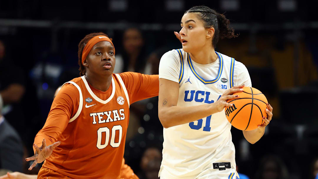Apr 3, 2026; Phoenix, AZ, USA; Texas Longhorns center Kyla Oldacre (00) defends against UCLA Bruins center Lauren Betts (51) during a semifinal of the Final Four of the women's 2026 NCAA Tournament at Mortgage Matchup Center. Mandatory Credit: Mark J. Rebilas-Imagn Images