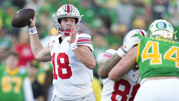 Ohio State Buckeyes quarterback Will Howard (18) throws during the first half of the College Football Playoff