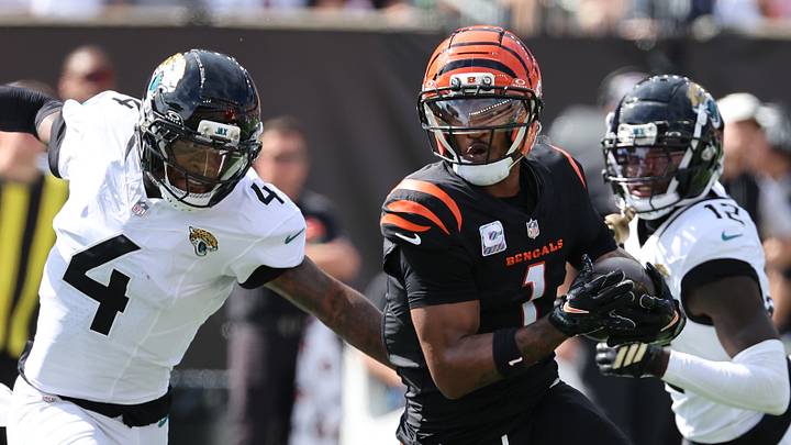 Oct 4, 2026; Cincinnati, Ohio, USA;  Cincinnati Bengals wide receiver Ja'Marr Chase (1) runs with a catch against Jacksonville Jaguars cornerback Jarrian Jones (4) during the second quarter at Paycor Stadium.  Mandatory Credit: Joseph Maiorana-Imagn Images