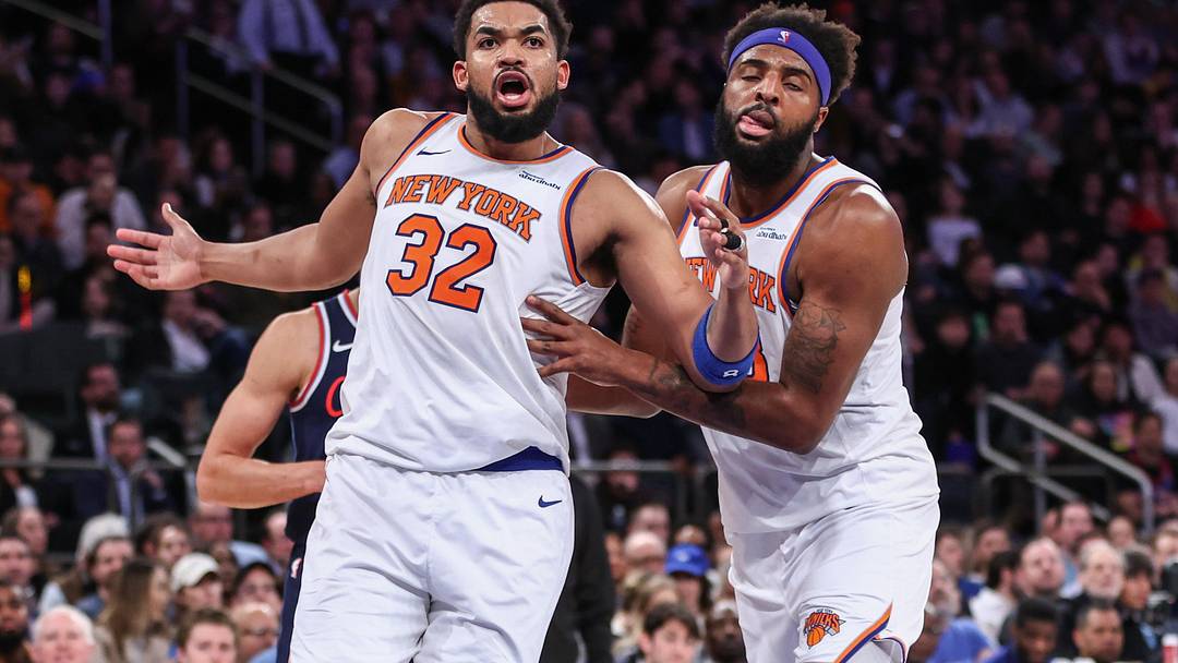 Mar 26, 2025; New York, New York, USA;  New York Knicks center Karl-Anthony Towns (32) is restrained by center Mitchell Robinson (23) in the fourth quarter against the LA Clippers at Madison Square Garden. Mandatory Credit: Wendell Cruz-Imagn Images