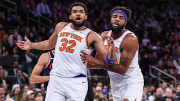 Mar 26, 2025; New York, New York, USA;  New York Knicks center Karl-Anthony Towns (32) is restrained by center Mitchell Robinson (23) in the fourth quarter against the LA Clippers at Madison Square Garden. Mandatory Credit: Wendell Cruz-Imagn Images