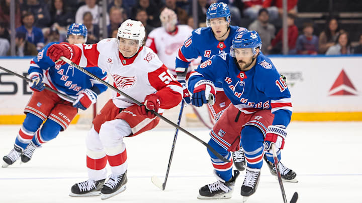 Apr 4, 2026; New York, New York, USA; Detroit Red Wings center Emmitt Finnie (58) and New York Rangers center Vincent Trocheck (16) chase the puck during the third period at Madison Square Garden. Mandatory Credit: Danny Wild-Imagn Images