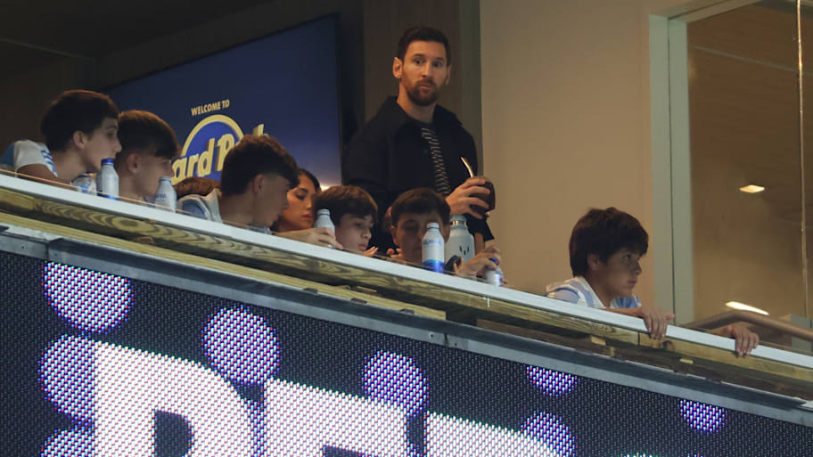 Lionel Messi watching from the sidelines.