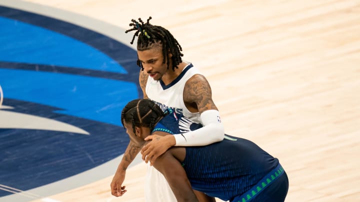 Apr 29, 2022; Minneapolis, Minnesota, USA; Memphis Grizzlies guard Ja Morant (12) and Minnesota Timberwolves guard Anthony Edwards (1) during game six of the first round for the 2022 NBA playoffs at Target Center. 