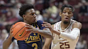 Feb 4, 2025; Tallahassee, Florida, USA; Notre Dame Fighting Irish guard Markus Burton (3) past Florida State Seminoles guard Justin Thomas (25) during the first half at Donald L. Tucker Center. Mandatory Credit: Melina Myers-Imagn Images