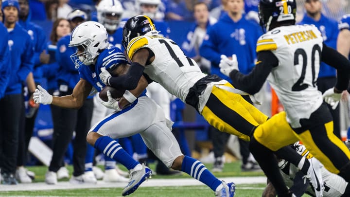 Dec 16, 2023; Indianapolis, Indiana, USA; Indianapolis Colts wide receiver D.J. Montgomery (2) runs with the ball while Pittsburgh Steelers safety Trenton Thompson (17) defends in the first half at Lucas Oil Stadium. Mandatory Credit: Trevor Ruszkowski-USA TODAY Sports