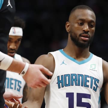 Apr 7, 2019; Detroit, MI, USA; Charlotte Hornets guard Kemba Walker (15) gives high fives to teammates as he walks to the bench during the second quarter against the Detroit Pistons at Little Caesars Arena. Mandatory Credit: Raj Mehta-USA TODAY Sports