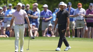 May 12, 2024; Charlotte, North Carolina, USA; Rory McIlroy reacts to his putt on the fifth green with Xander Schauffele during the final round of the Wells Fargo Championship golf tournament. Mandatory Credit: Jim Dedmon-USA TODAY Sports