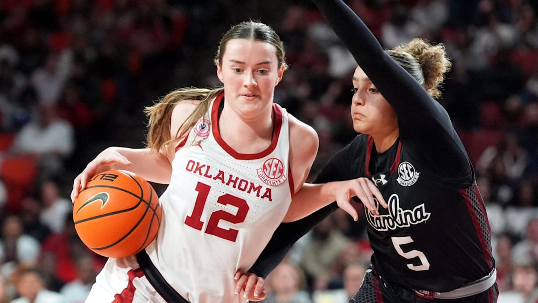 Oklahoma's Payton Verhulst (12) drives to the basket as South Carolina 's Tessa Johnson (5) defends in the second half of the women's college basketball game between the Oklahoma Sooners and the South Carolina at the Lloyd Noble Center in Norman, Okla., Thursday Jan. 22, 2026. Oklahoma's Payton Verhulst (12) drives to the basket as South Carolina 's Tessa Johnson (5) defends in the second half of the women's college basketball game between the Oklahoma Sooners and the South Carolina at the Lloyd Noble Center in Norman, Okla., Thursday Jan. 22, 2026.