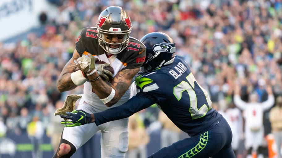 Nov 3, 2019; Seattle, WA, USA; Tampa Bay Buccaneers wide receiver Mike Evans (13) fights for yards while being tackled by Seattle Seahawks defensive back Marquise Blair (27) during the second half at CenturyLink Field. Seattle defeated Tampa Bay 40-34. Mandatory Credit: Steven Bisig-USA TODAY Sports | Steven Bisig-USA TODAY Sports