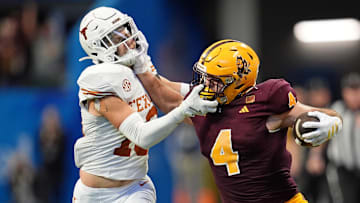 Jan 1, 2025; Atlanta, GA, USA; Arizona State Sun Devils running back Cam Skattebo (4) and Texas Longhorns defensive back Michael Taaffe (16) push each other during the second half of the Peach Bowl at Mercedes-Benz Stadium. Mandatory Credit: Dale Zanine-Imagn Images