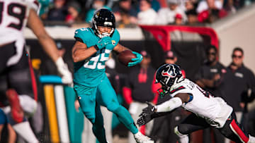 Dec 1, 2024; Jacksonville, Florida, USA; Jacksonville Jaguars tight end Brenton Strange (85) runs after the catch against Houston Texans cornerback Kamari Lassiter (4) in the third quarter  at EverBank Stadium. 