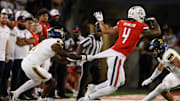 Sep 7, 2024; Tucson, Arizona, USA; Northern Arizona Lumberjacks center back DJ Vanhook (4) attempts to tackle Arizona Wildcats wide receiver Tetairoa McMillan (4) during the third quarter at Arizona Stadium.