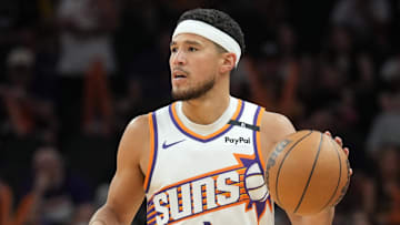 Apr 11, 2025; Phoenix, Arizona, USA; Phoenix Suns guard Devin Booker (1) dribbles against the San Antonio Spurs during the second half at Footprint Center. Mandatory Credit: Joe Camporeale-Imagn Images