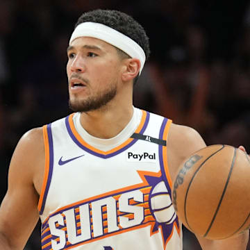 Apr 11, 2025; Phoenix, Arizona, USA; Phoenix Suns guard Devin Booker (1) dribbles against the San Antonio Spurs during the second half at Footprint Center. Mandatory Credit: Joe Camporeale-Imagn Images