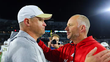 Nov 21, 2024; Atlanta, Georgia, USA; Georgia Tech Yellow Jackets head coach Brent Key talks to North Carolina State Wolfpack head coach Dave Doeren after a game at Bobby Dodd Stadium at Hyundai Field. Mandatory Credit: Brett Davis-Imagn Images
