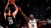 Jan 3, 2024; Houston, Texas, USA; Houston Rockets center Alperen Sengun (28) shoots against Brooklyn Nets forward Dorian Finney-Smith (28) during the first quarter at Toyota Center. Mandatory Credit: Erik Williams-USA TODAY Sports